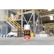 A photo of GorillaPro AT105GEL threadlocker in the foreground, and an industrial warehouse in the background, out of focus. (Product image)