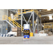 A photo of GorillaPro AT160 Gel threadlocker in the foreground, and an industrial warehouse in the background, out of focus. (Product image)