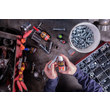 An overhead view of an MRO professional applying GorillaPro AT105GEL threadlocking compound to a threaded bolt. (Product image)