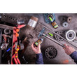 An overhead view of an MRO professional applying GorillaPro AR250 green retaining compound (slip fit) to a shiny steel rod. (Product image)