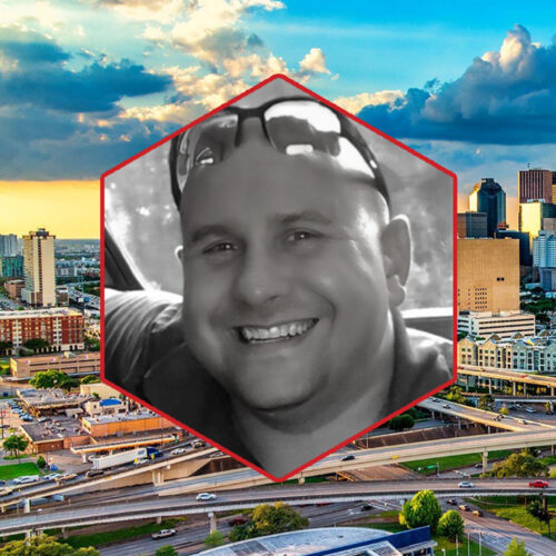 Senior SupplySight™ Sales Specialist Nick Freeman smiling in portrait framed in a red hexagon, overlaid on a vibrant cityscape of Houston, Texas.
