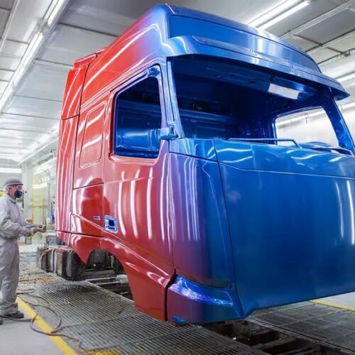 A truck cab being prepped and painted in a paint bay